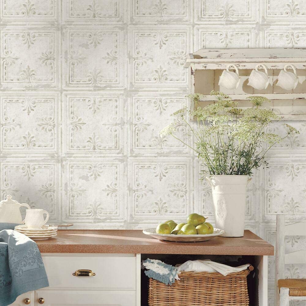 A farmhouse kitchen counter featuring textured faux tin tile wallpaper, a distressed wood wall shelf, and a wicker basket.