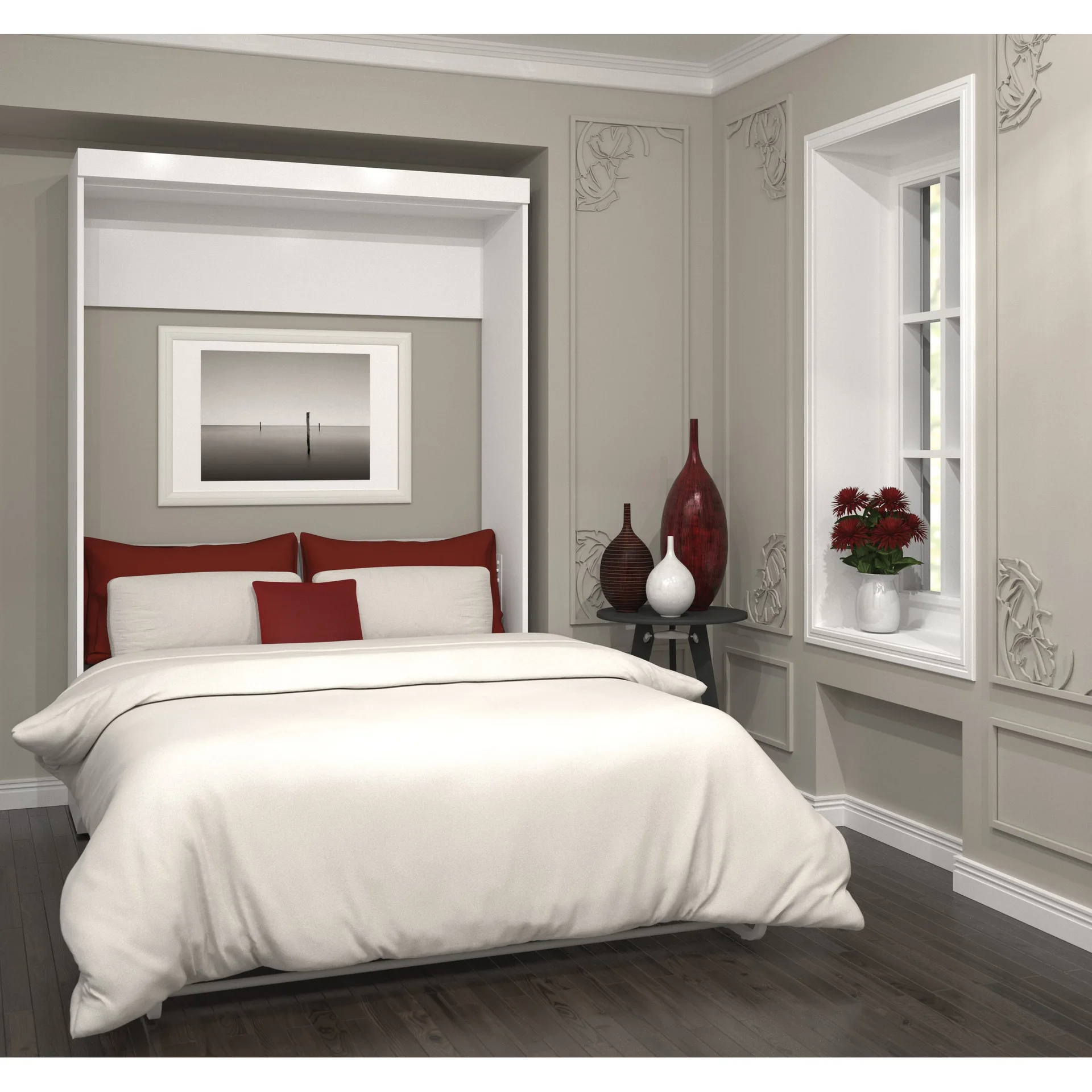A white Murphy bed is dressed in white and red bedding next to a gray wall featuring ornate moldings, a small side table, and a window.
