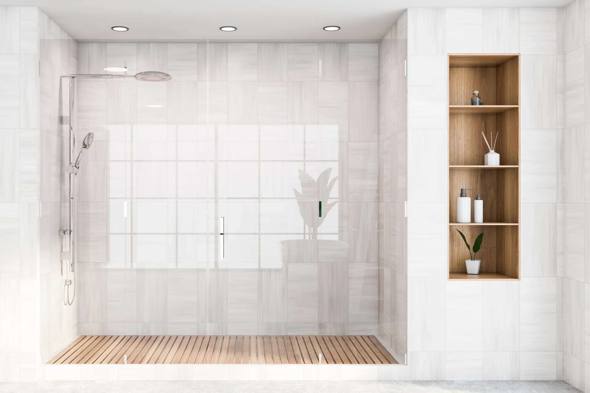 A modern glass walk-in shower features light grey wall tiles, a warm wood-slatted floor, and a tall built-in wooden shelving niche.