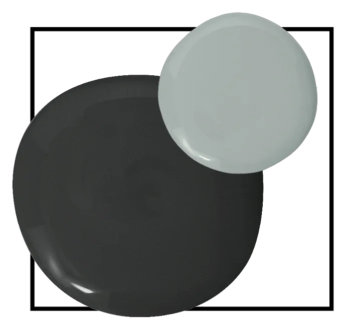 Two glossy circular paint samples in charcoal gray and sage green overlap within a thin black square frame on a white background.
