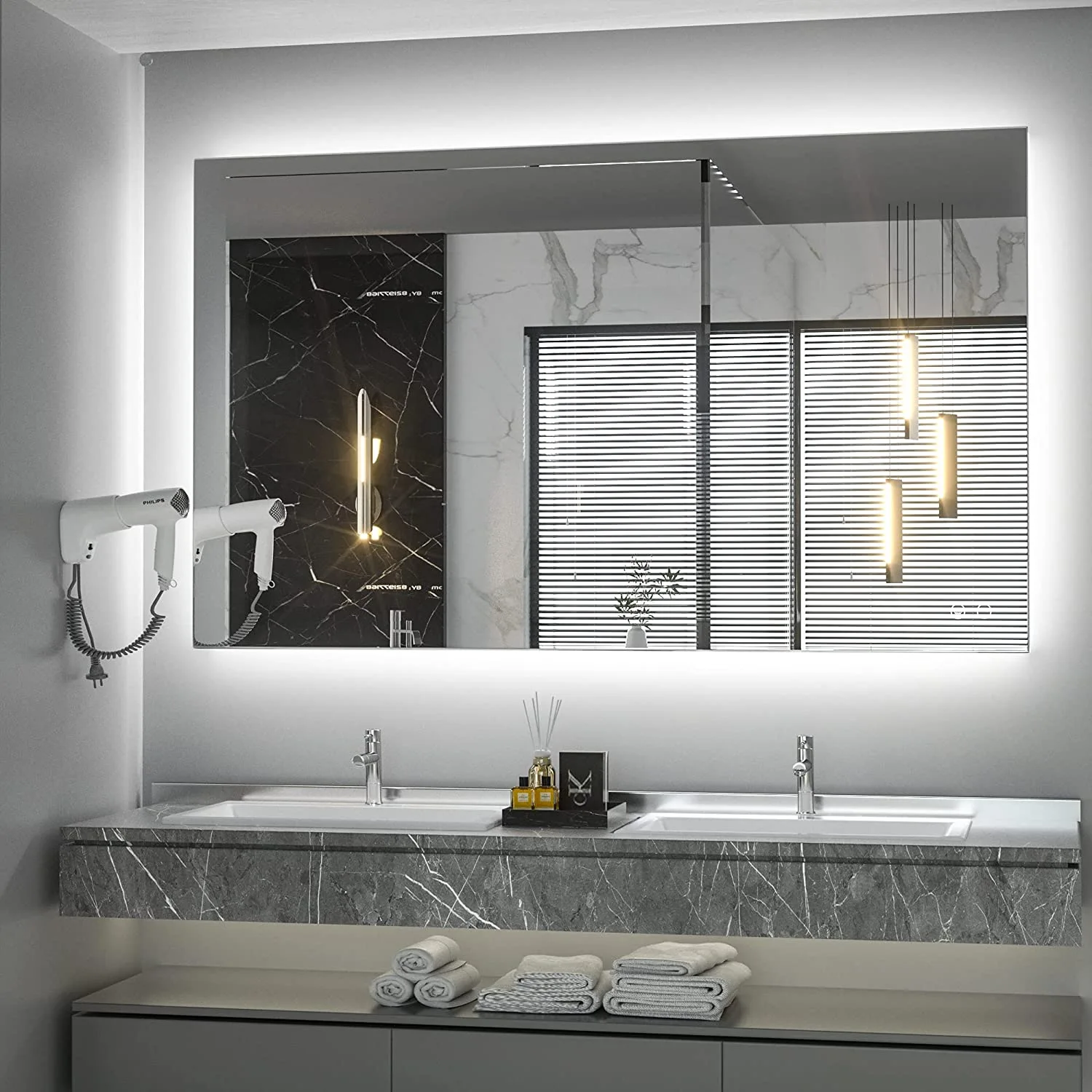 A modern bathroom features a gray veined marble double vanity with chrome faucets beneath a large, rectangular LED-backlit mirror.