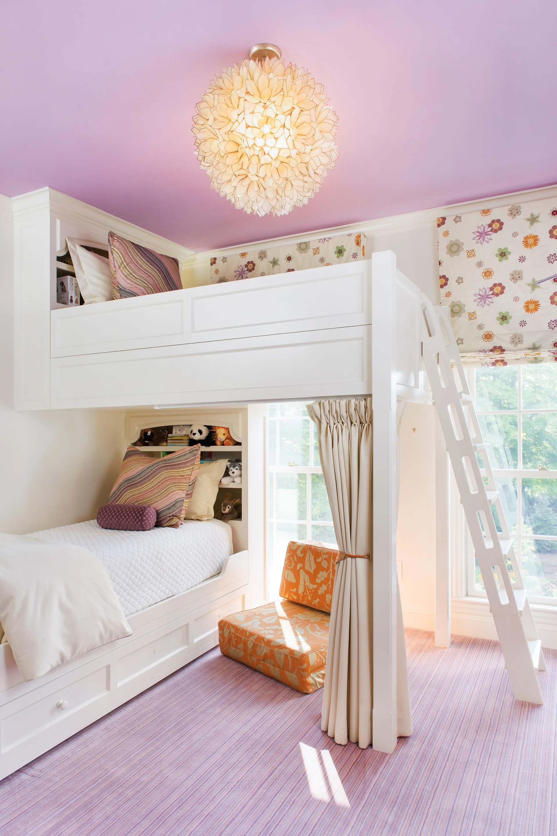 A kids bedroom features a white built-in bunk bed with a wooden ladder, a purple striped carpet, and a lavender ceiling with a floral pendant light.