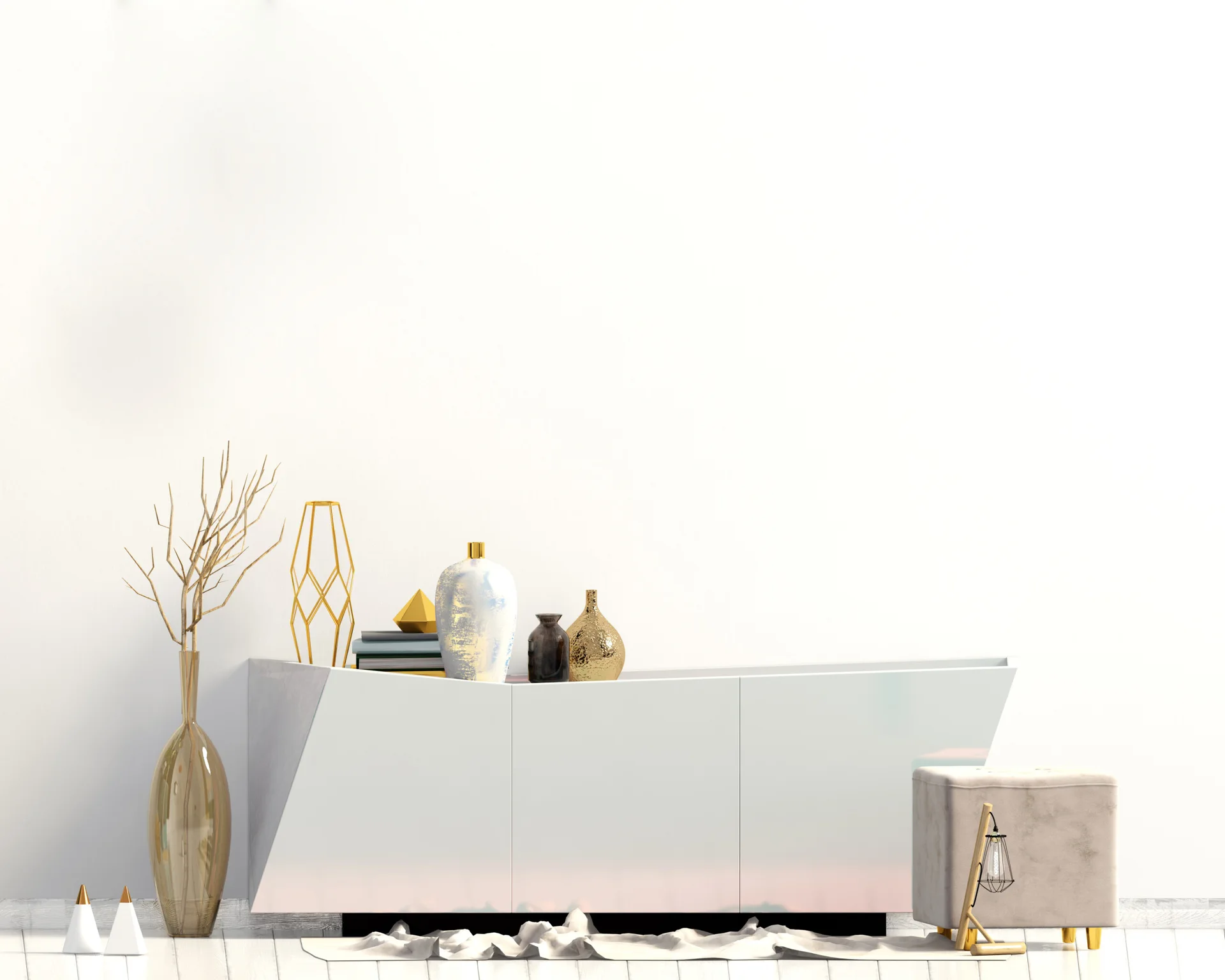 A minimalist white sideboard sits against a plain wall, decorated with a gold geometric sculpture, several vases, and a small square ottoman nearby.