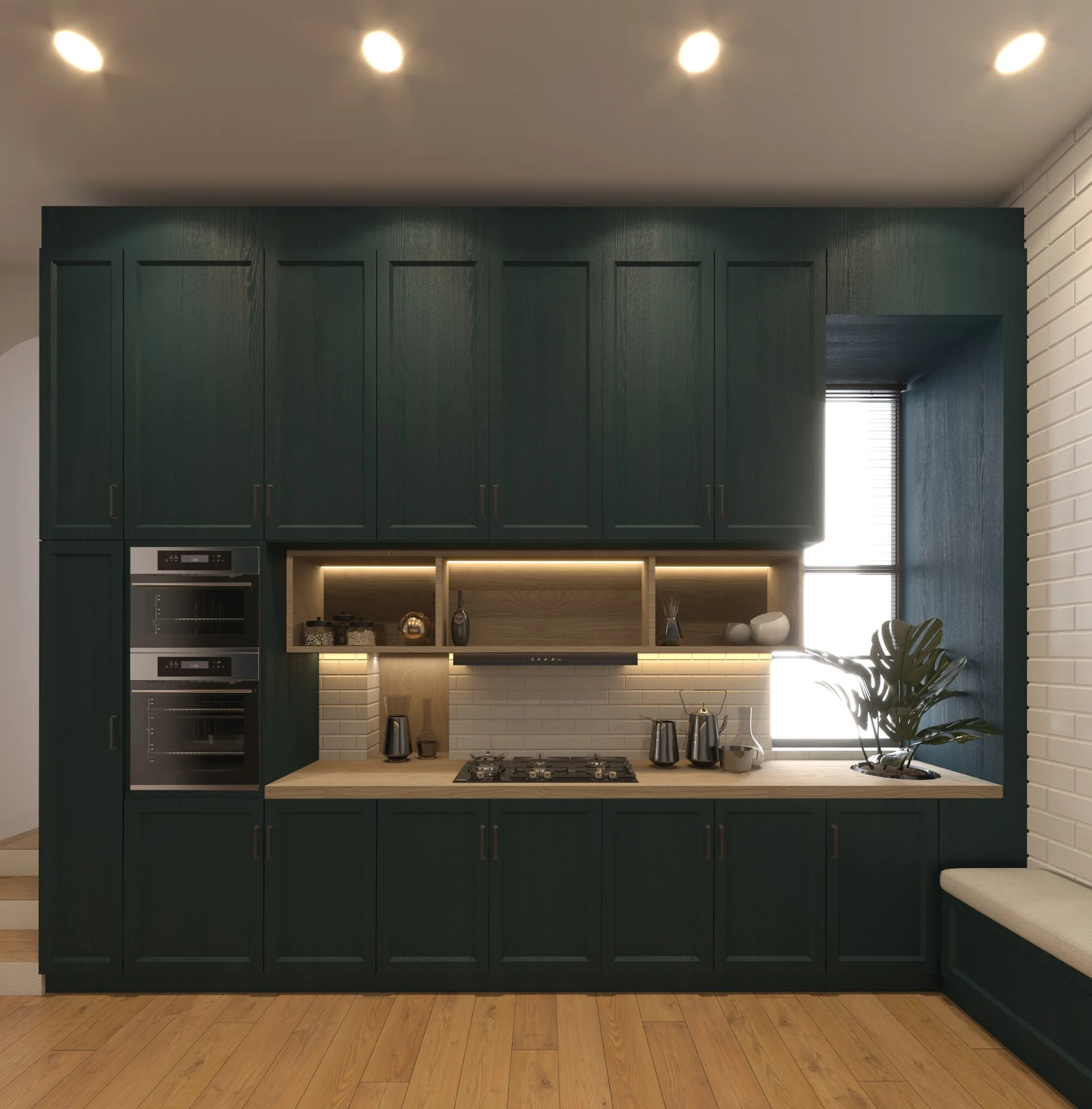 A modern kitchen with deep green cabinets, light wood countertops, integrated open shelving, a white brick wall, and built-in double ovens.