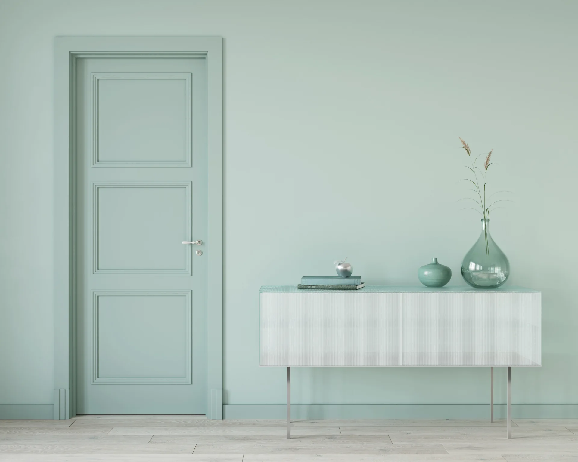 A minimalist green entryway features a mint green paneled door, matching painted wall, and a white fluted glass console table on slim legs.