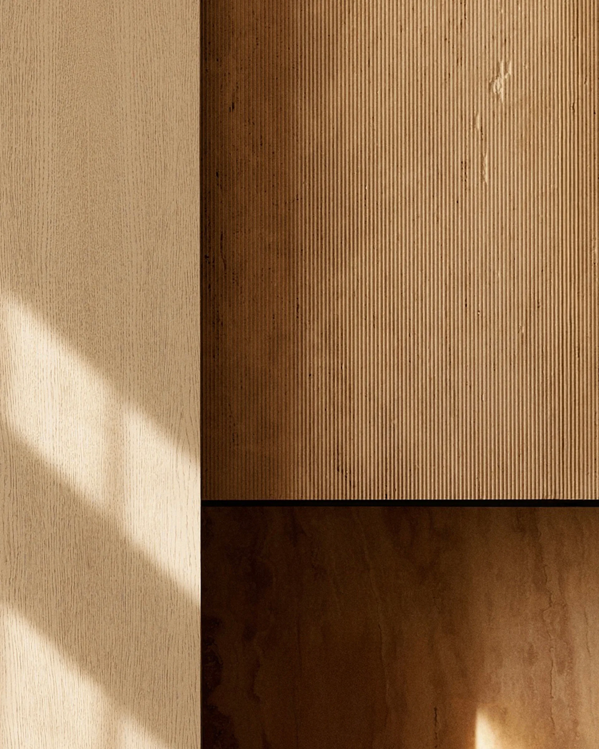 A close-up of modern beige wood wall paneling showing a flat panel alongside a finely ribbed, fluted panel with diagonal shadows.
