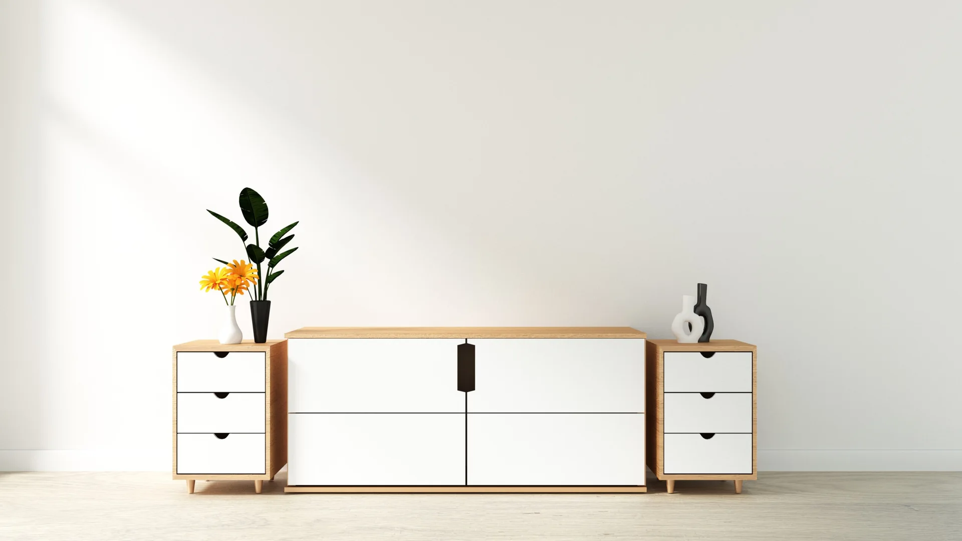 A symmetrical arrangement of a central light wood console and two matching side drawer units with white fronts sits against a plain white wall.