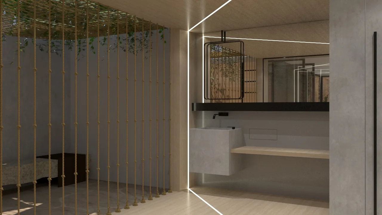 A modern bathroom with a grey concrete floating sink, a light wood shelf, a black-framed mirror, and a vertical rope partition screen.