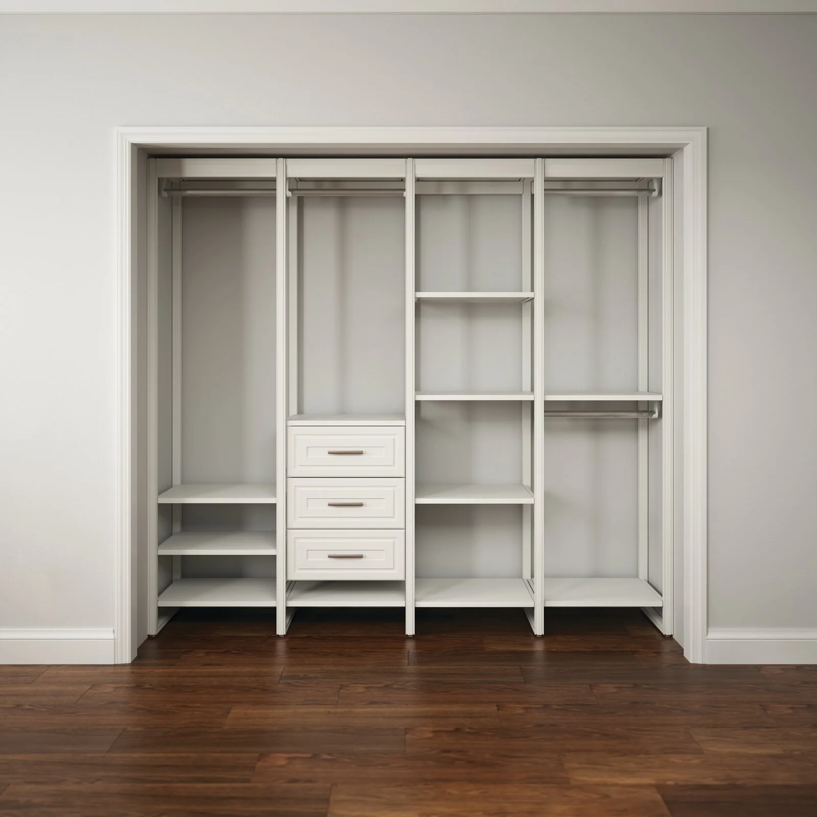 An empty white built-in closet system with shelves, rods, and drawers stands in an alcove over dark wood floors.