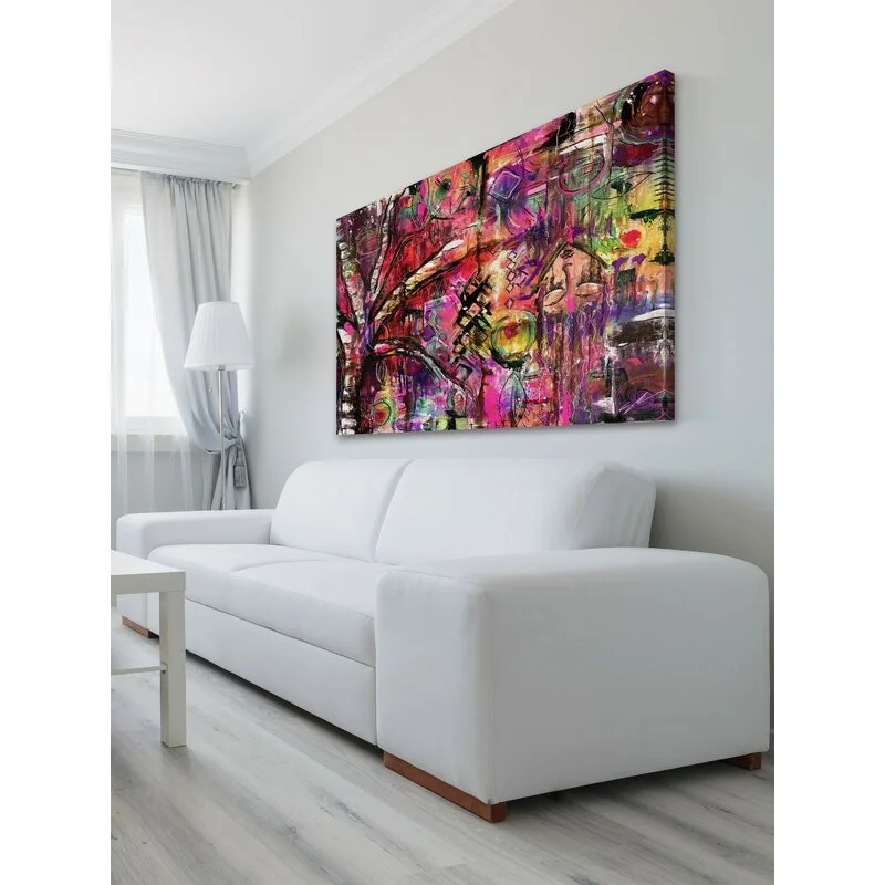 A large, colorful abstract painting hangs on a white wall above a minimalist white sofa, with a floor lamp and gray curtain in the background.