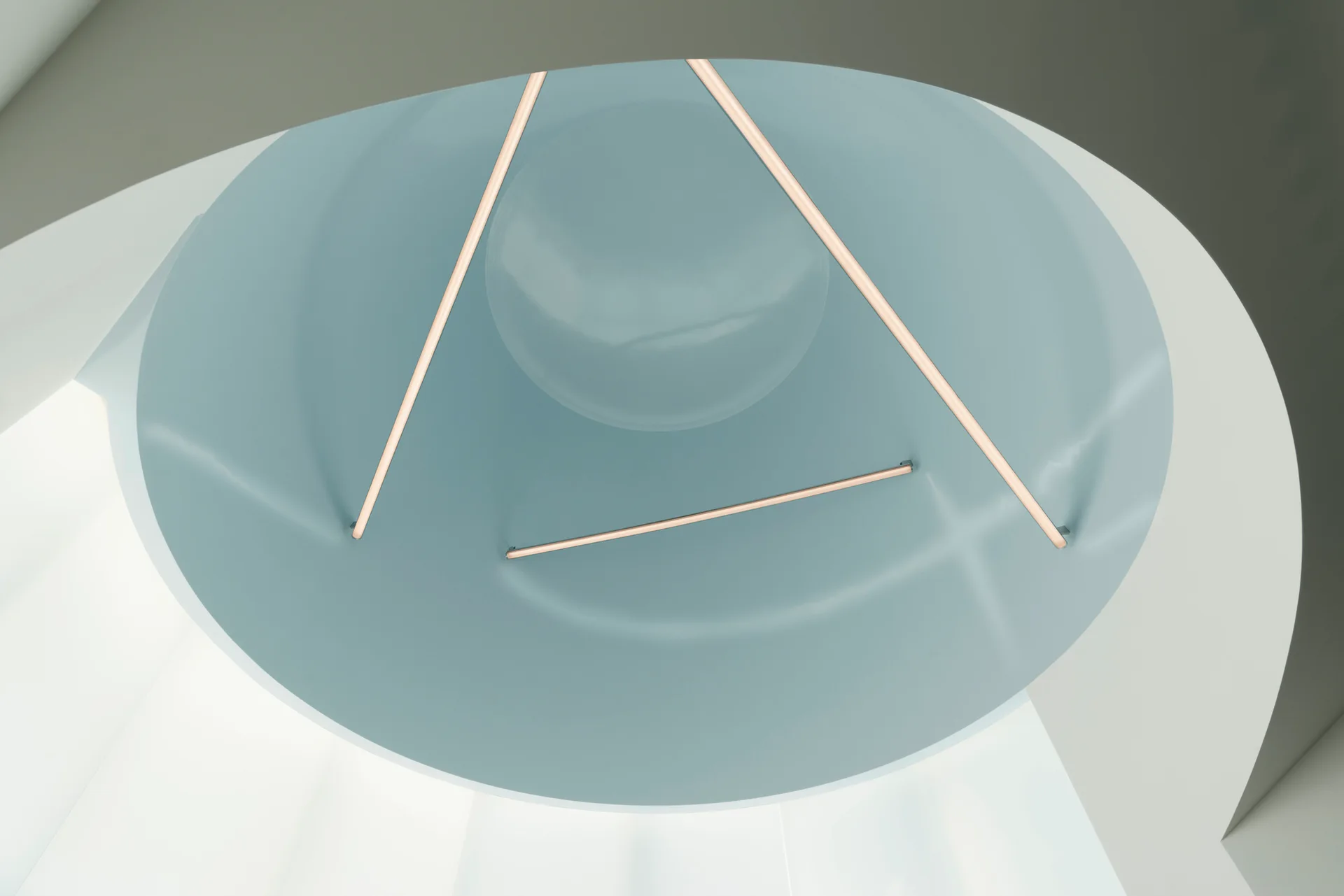 A circular recessed ceiling cove painted in pale blue is accented by minimalist linear light fixtures set against a white architectural curved background.