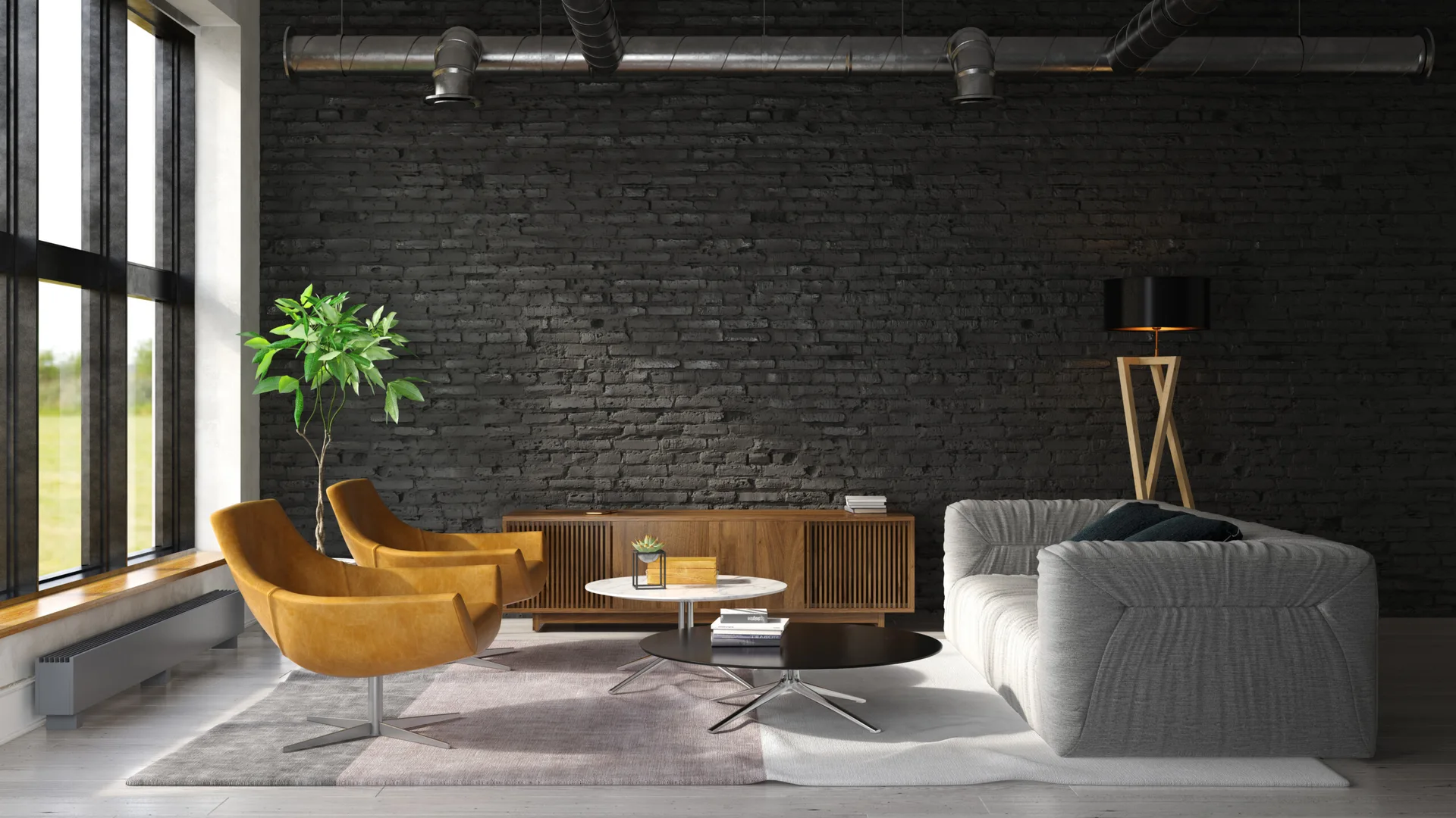 An industrial living room featuring a dark painted brick wall, two tan leather swivel chairs, a grey sofa, and exposed ceiling ductwork.