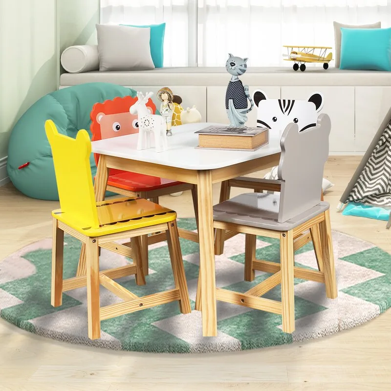 A children's play table with colorful animal-shaped chairs sits on a round chevron rug in a bright playroom.