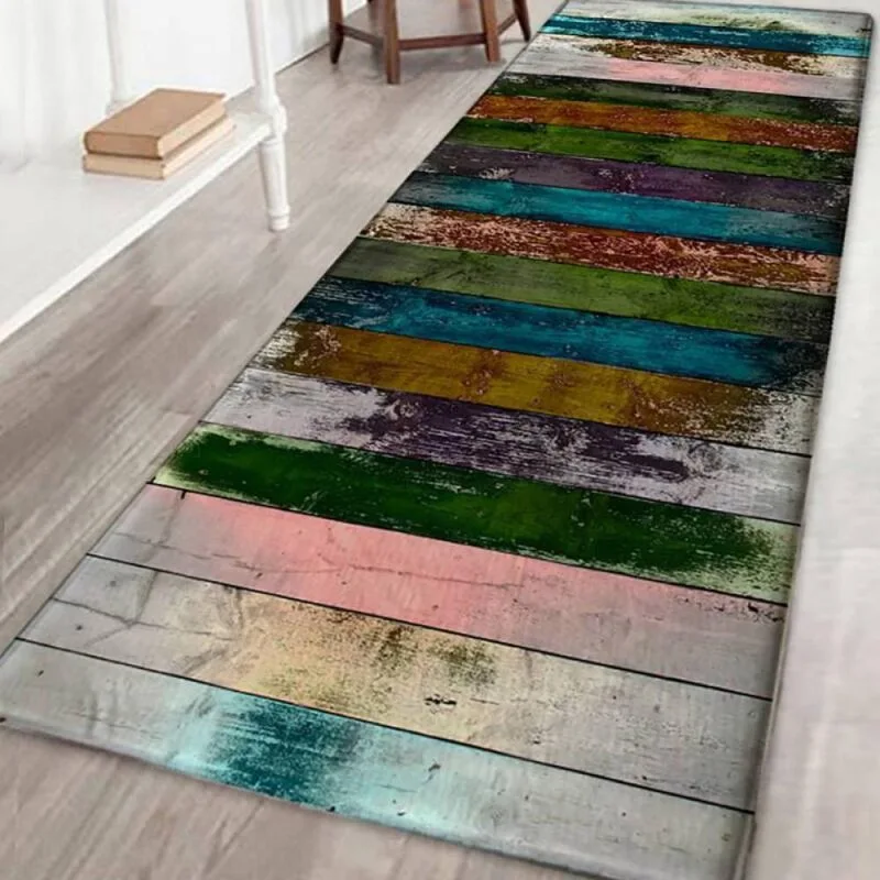 A long runner rug with a multicolored faux wood plank pattern lies on a light wooden floor next to a white console table.