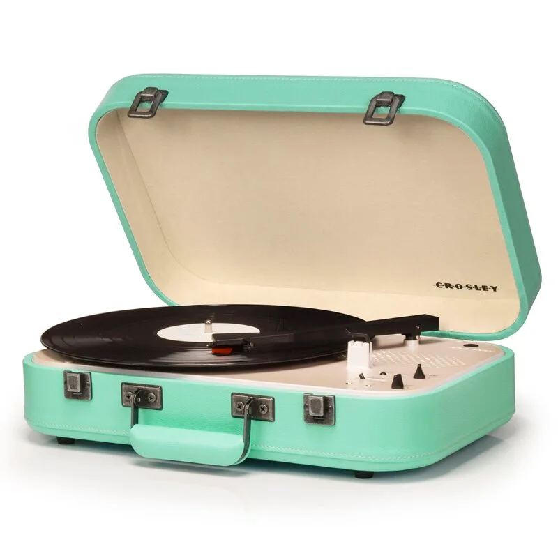 A portable mint green suitcase-style record player is open with a black vinyl record on the turntable.