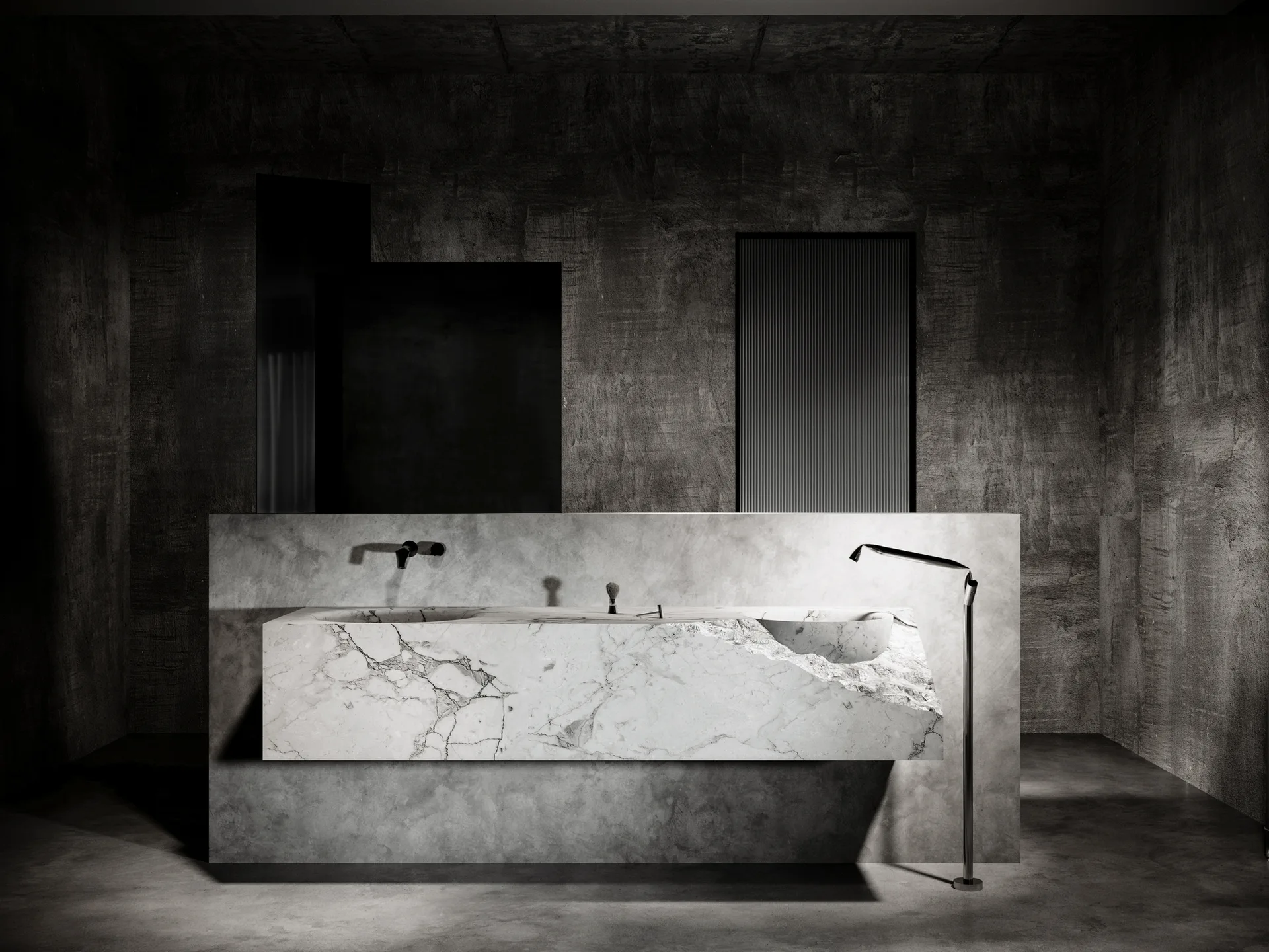 A minimalist dark bathroom features a wall-mounted sculptural white marble vanity with a raw stone edge beneath a black faucet and moody lighting.