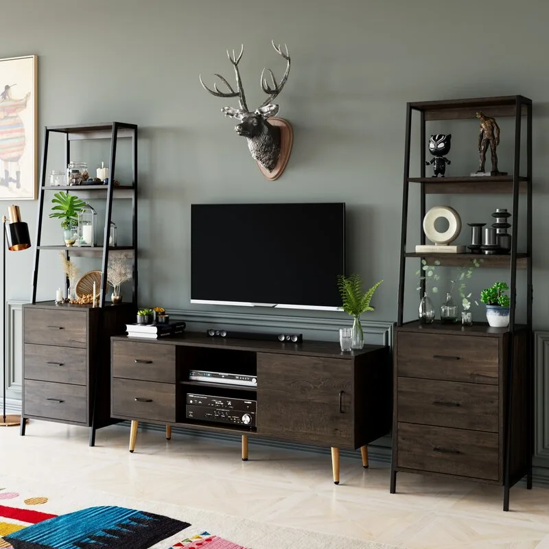 A dark wood media console and two matching ladder bookshelves sit against a sage green wall featuring a mounted television and a deer sculpture.