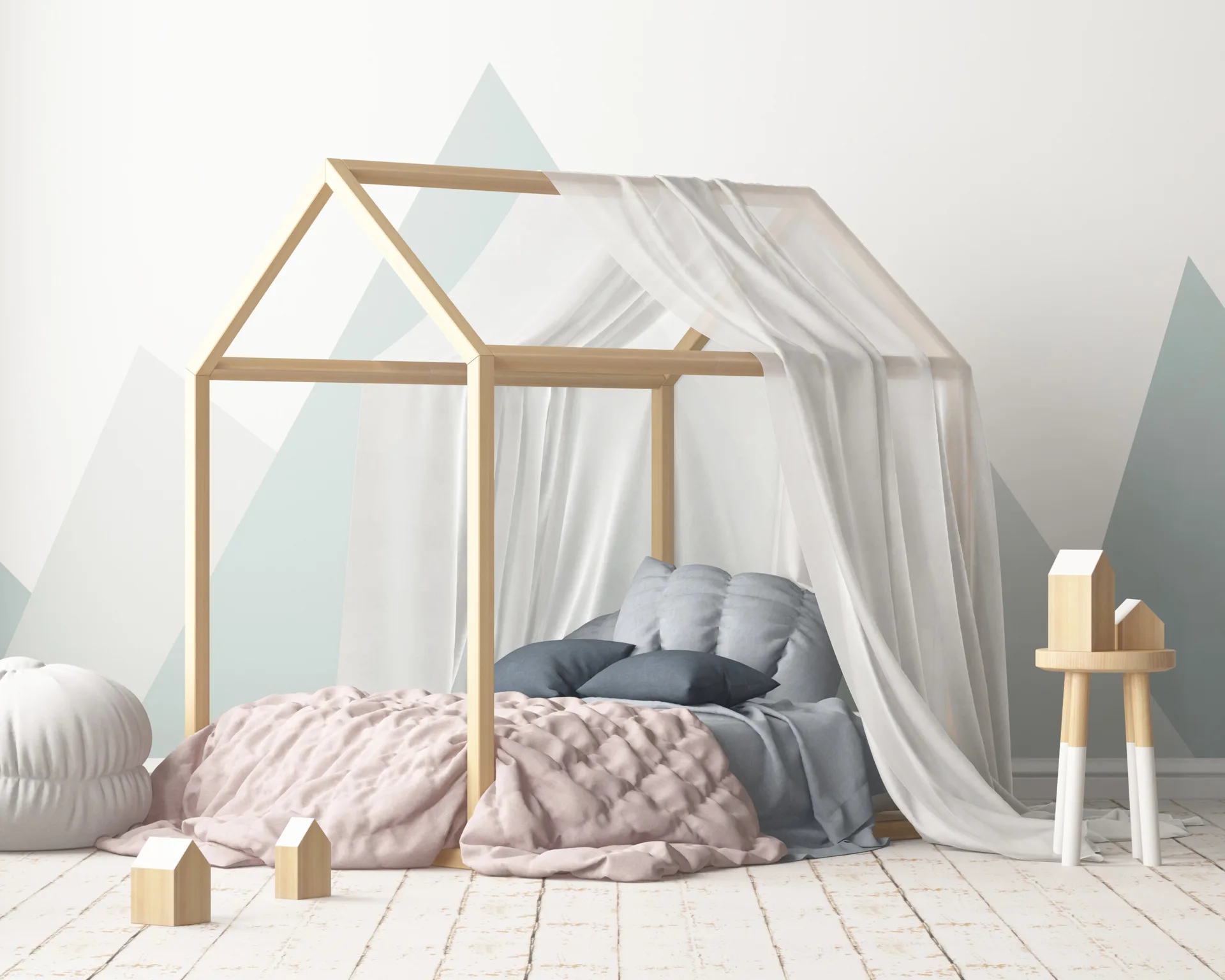 A children's bedroom features a light wood house-frame bed with a sheer white canopy set against a geometric mountain mural and white plank floors.
