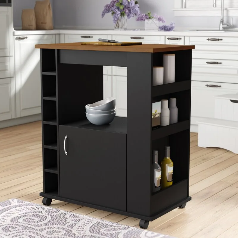 A matte black rolling kitchen island cart with a wood top and open shelving stands on a light hardwood floor.