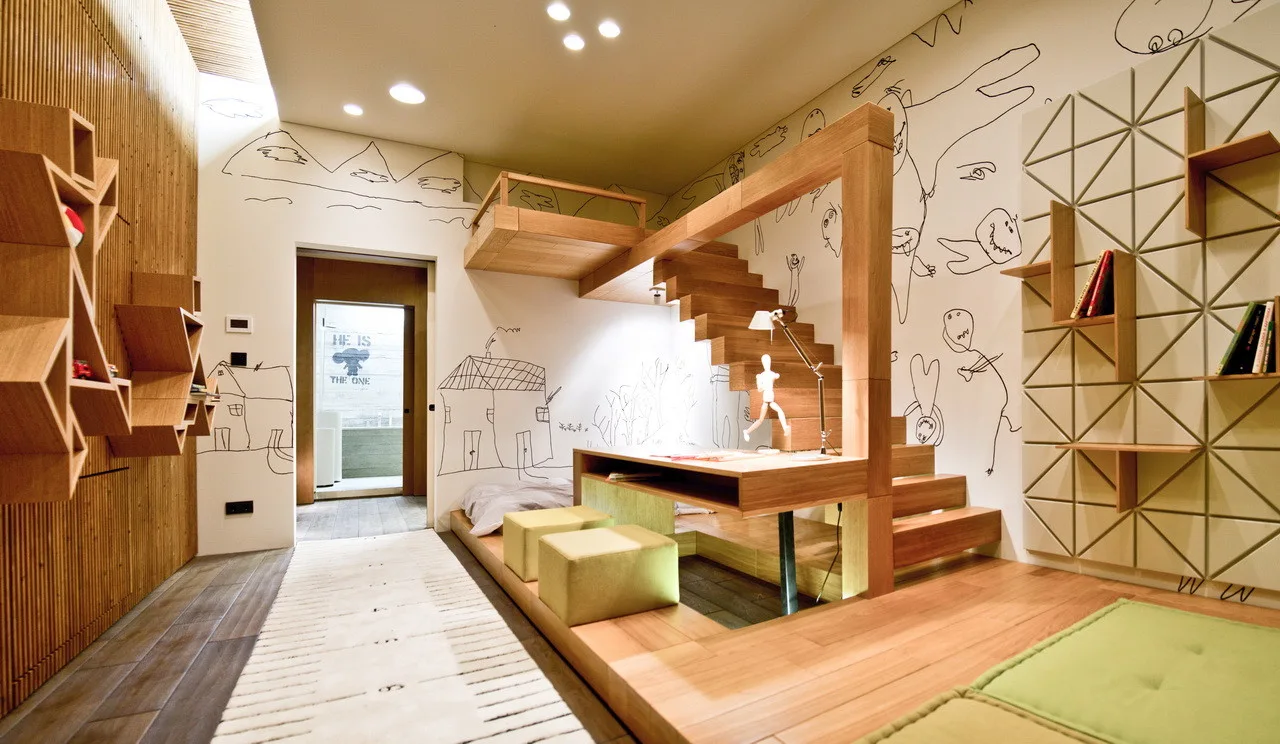 A child's bedroom featuring custom light wood furniture with an integrated loft bed, staircase, and desk set against white walls with hand-drawn sketches.