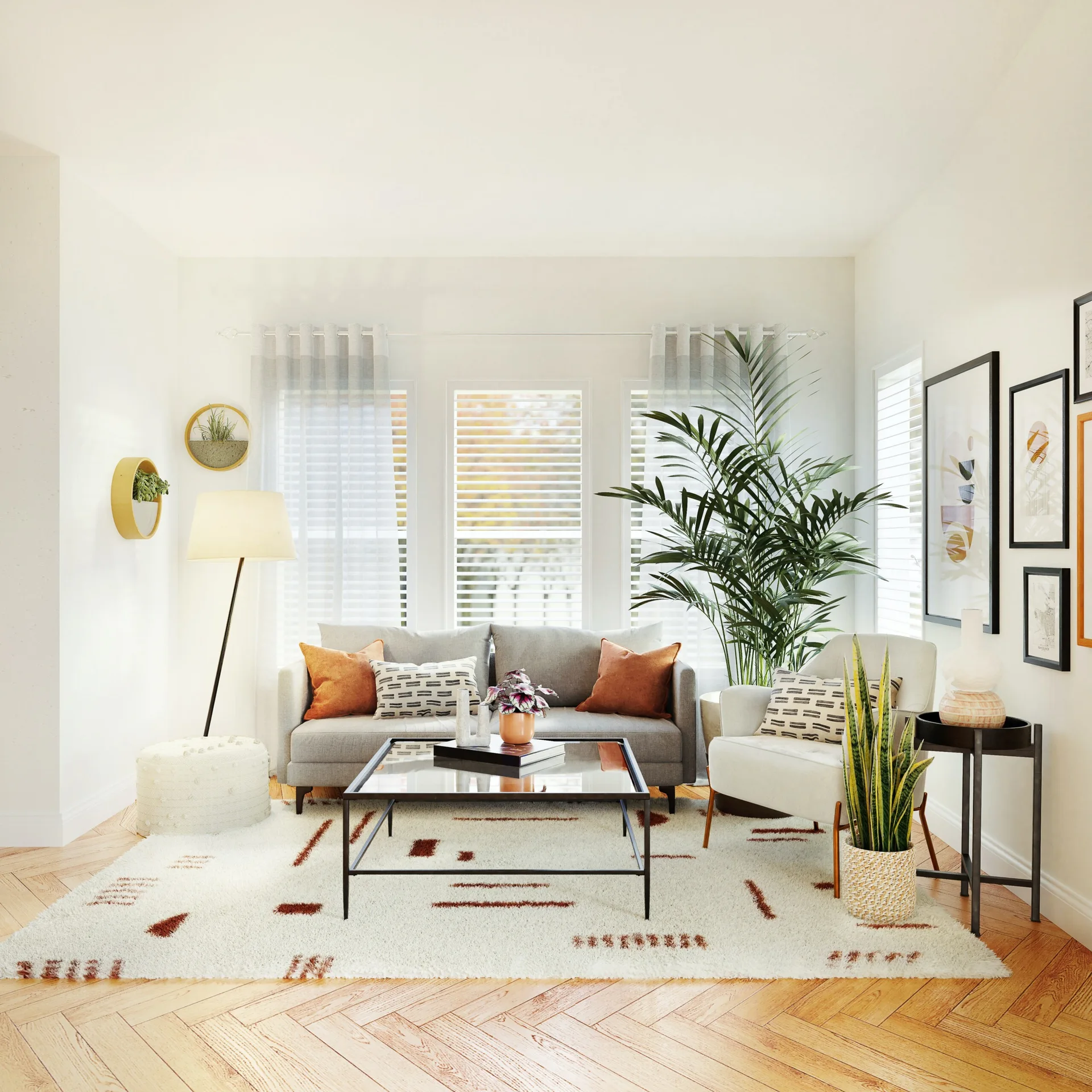 A bright living room features a grey sofa, herringbone wood flooring, a glass coffee table, and large potted plants.