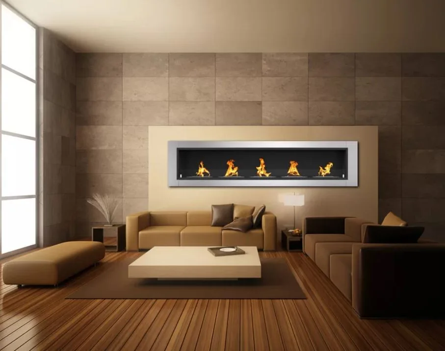 A minimalist living room featuring brown sofas, a low beige coffee table, and a wide wall-mounted linear fireplace set against stone tiles.