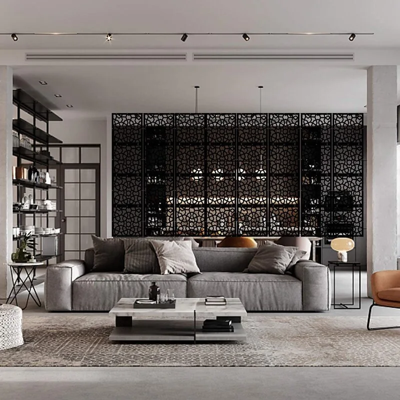 A contemporary living room features a grey low-profile sofa, a layered marble coffee table, and a large black geometric partition screen.