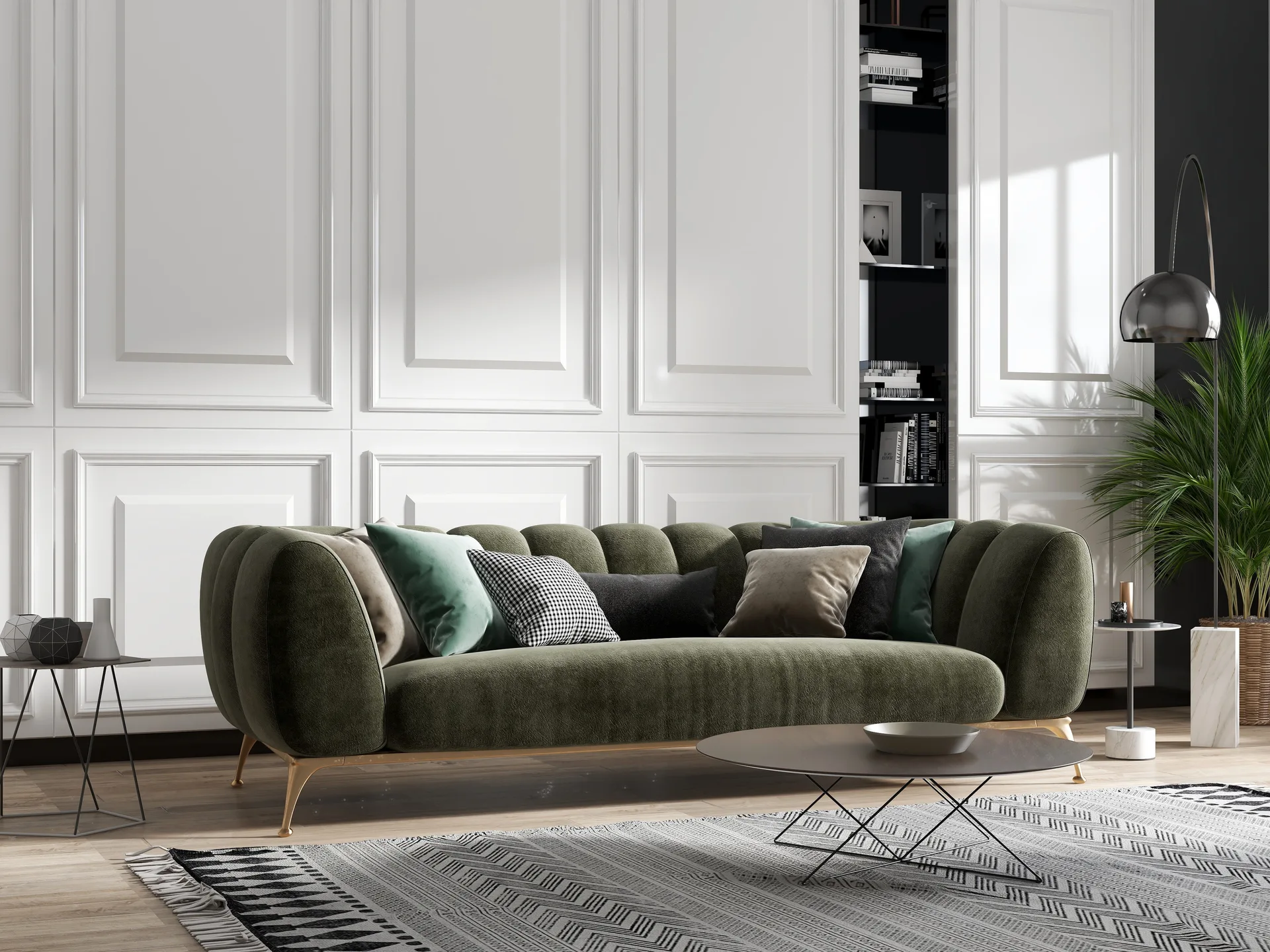 An olive green tufted sofa sits against a white paneled wall next to a recessed black bookcase and a geometric patterned area rug.