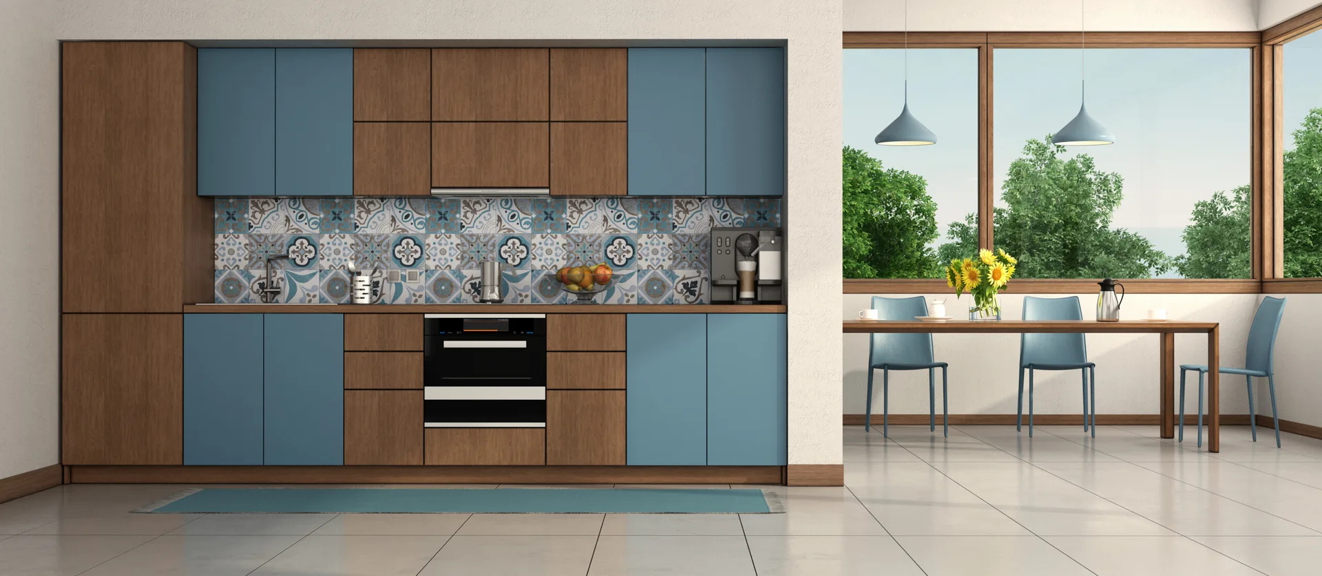 A modern kitchen and dining area with matte blue and wood cabinets, a patterned tile backsplash, and a dining table set near a large window.
