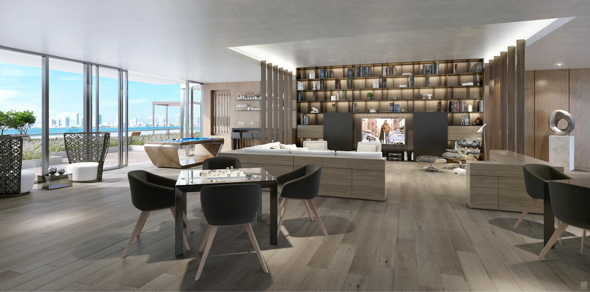 An open-plan lounge featuring a large built-in wooden bookcase, a billiards table, and floor-to-ceiling windows overlooking a coastal skyline.