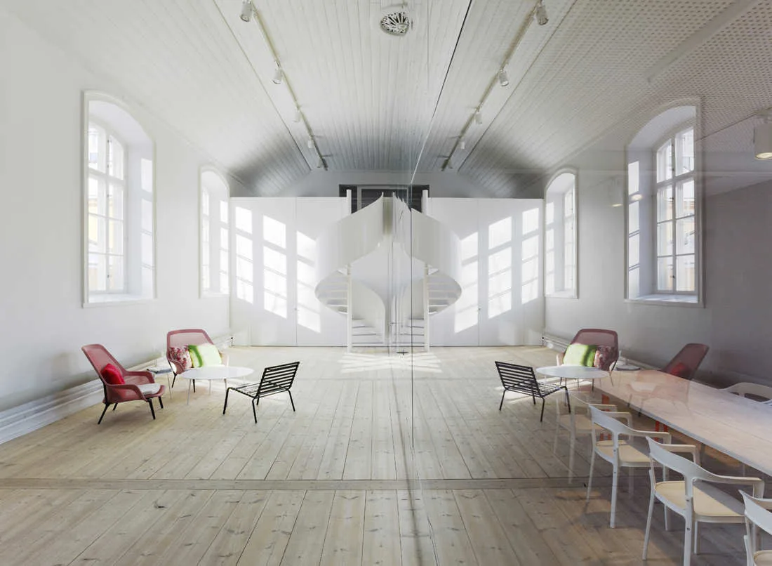 A spacious minimalist room featuring a central white spiral staircase, light wood plank floors, arched windows, and pink and black armchairs.
