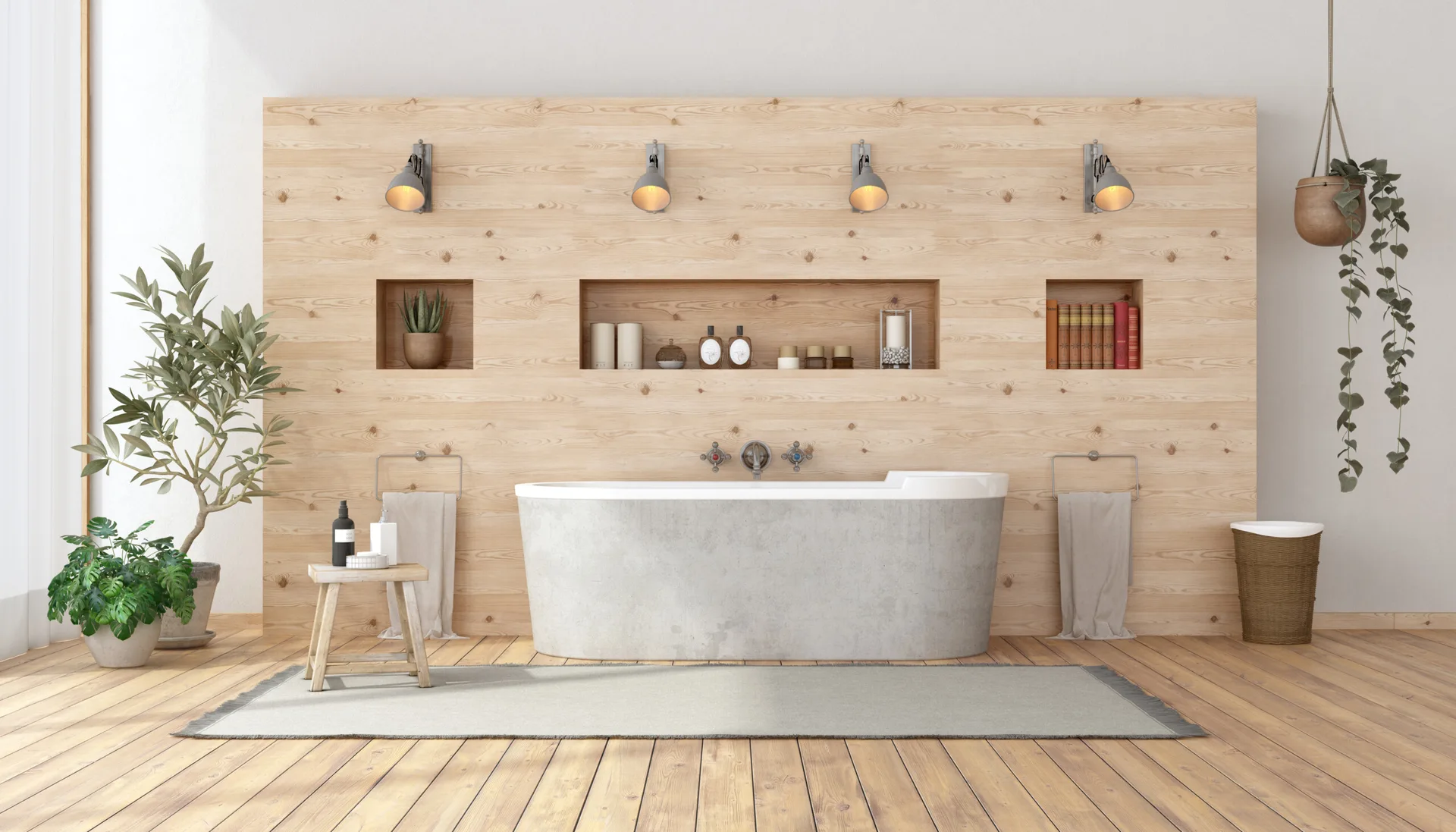 A minimalist bathroom featuring a concrete freestanding tub in front of a light wood paneled wall with recessed shelves and wall sconces.