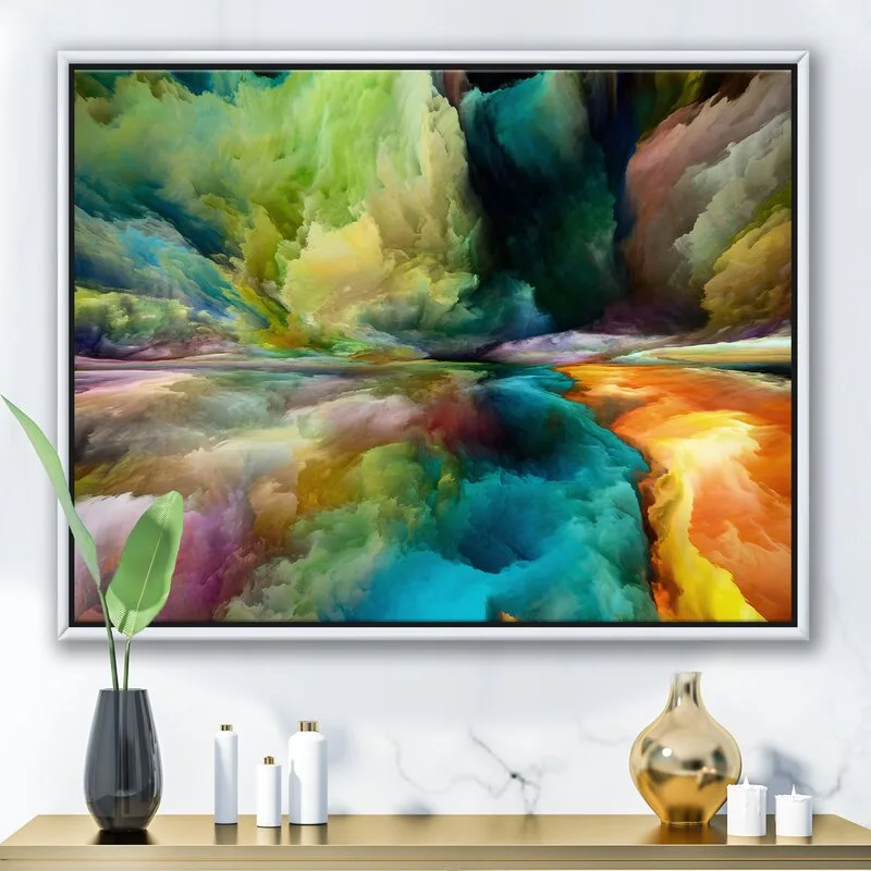 A framed colorful abstract landscape painting hangs on a white marbled wall above a gold console table styled with decorative bottles and candles.