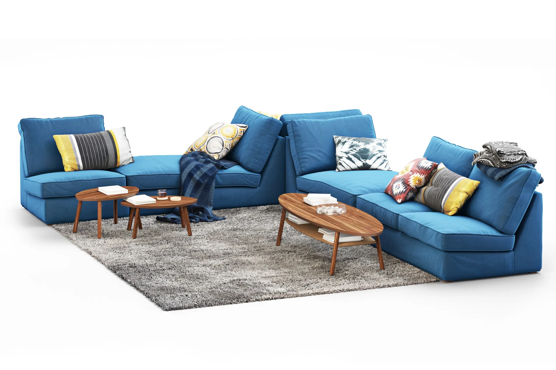 A blue modular sectional sofa with patterned throw pillows is arranged on a grey shag rug around three oval wooden coffee tables.