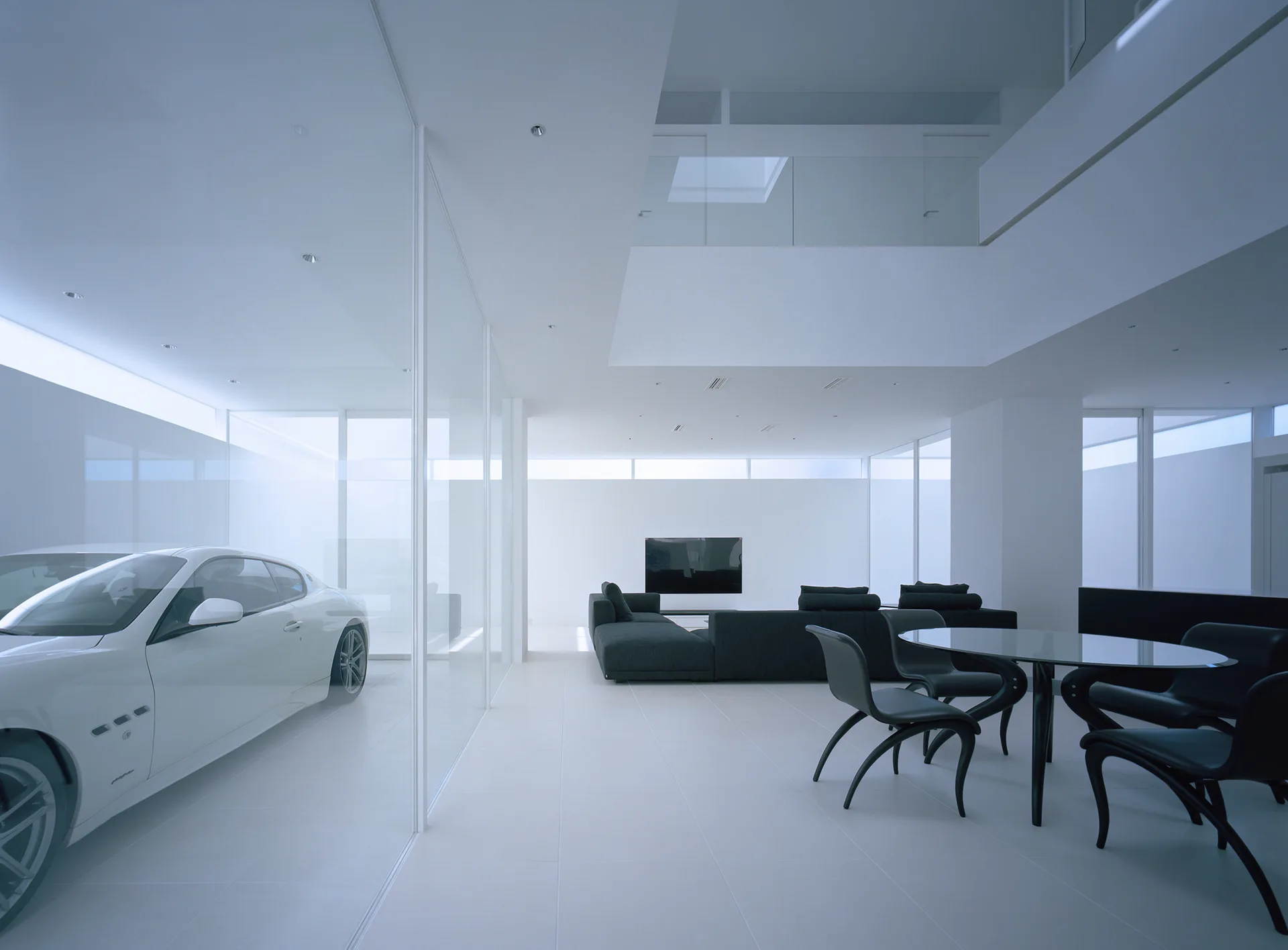 A stark white minimalist living room features a black sectional sofa, a glass-topped dining set, and a glass-enclosed garage with a white sports car.