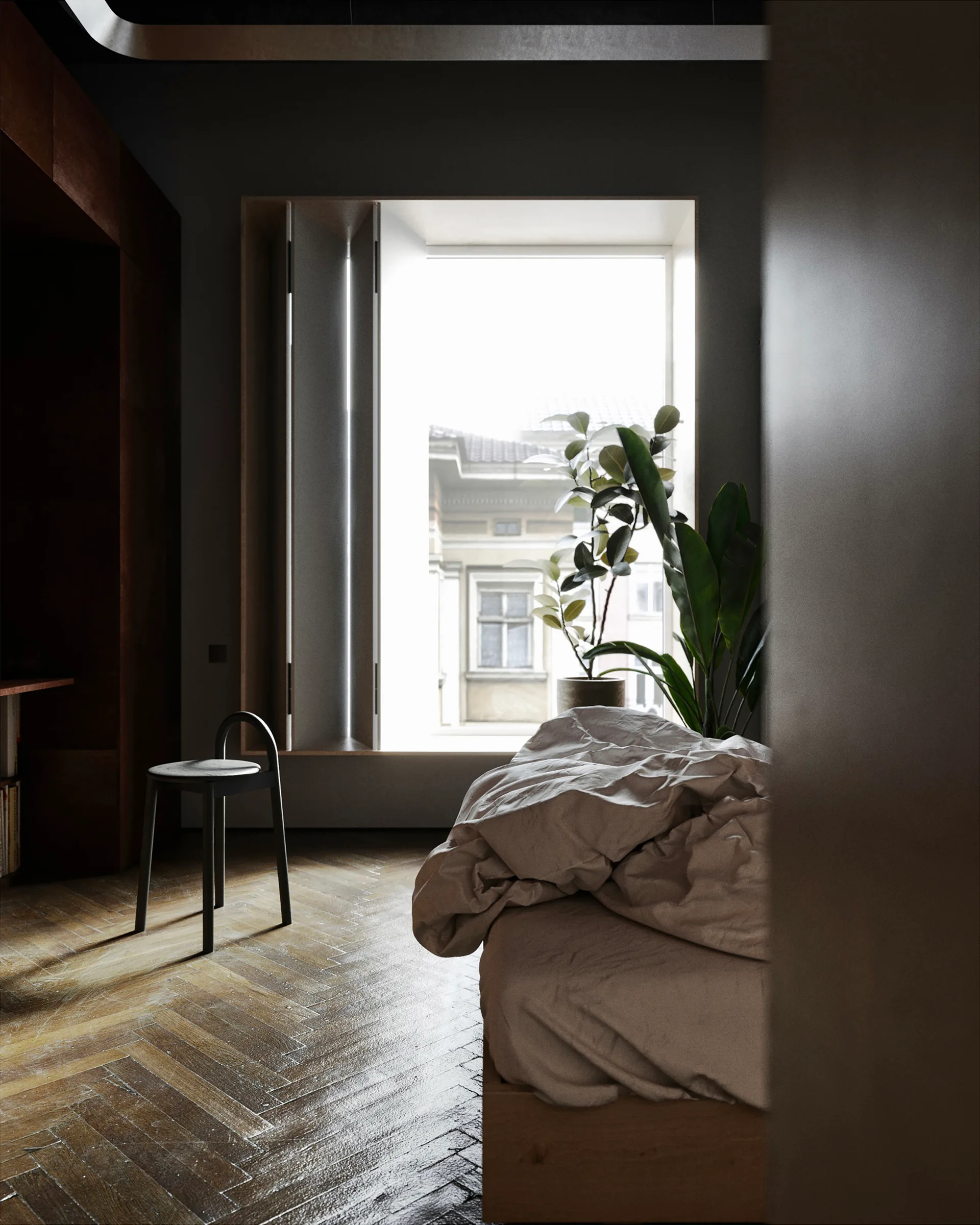 A moody bedroom featuring a bed with rumpled linens, a single black stool, a potted plant, and a large deep-set window overlooking a building.