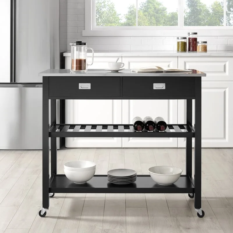 A black rolling kitchen cart with a silver metal countertop, middle wine rack, and lower shelf stands in a bright white kitchen.