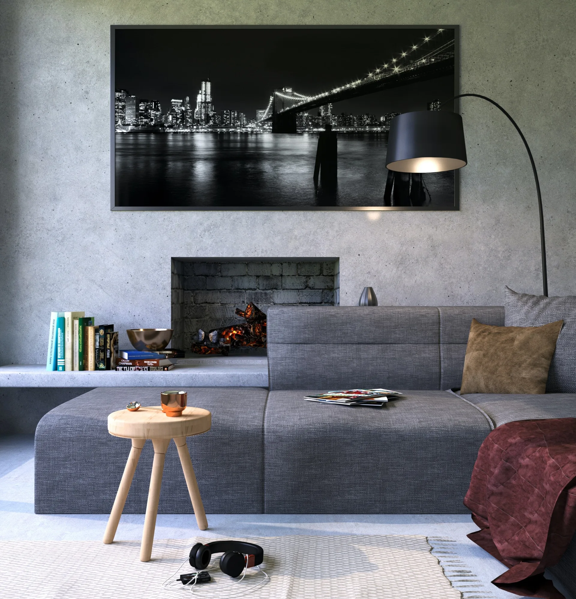 A modern living room featuring a grey sectional sofa, an exposed concrete fireplace wall, and a large black and white skyline print.