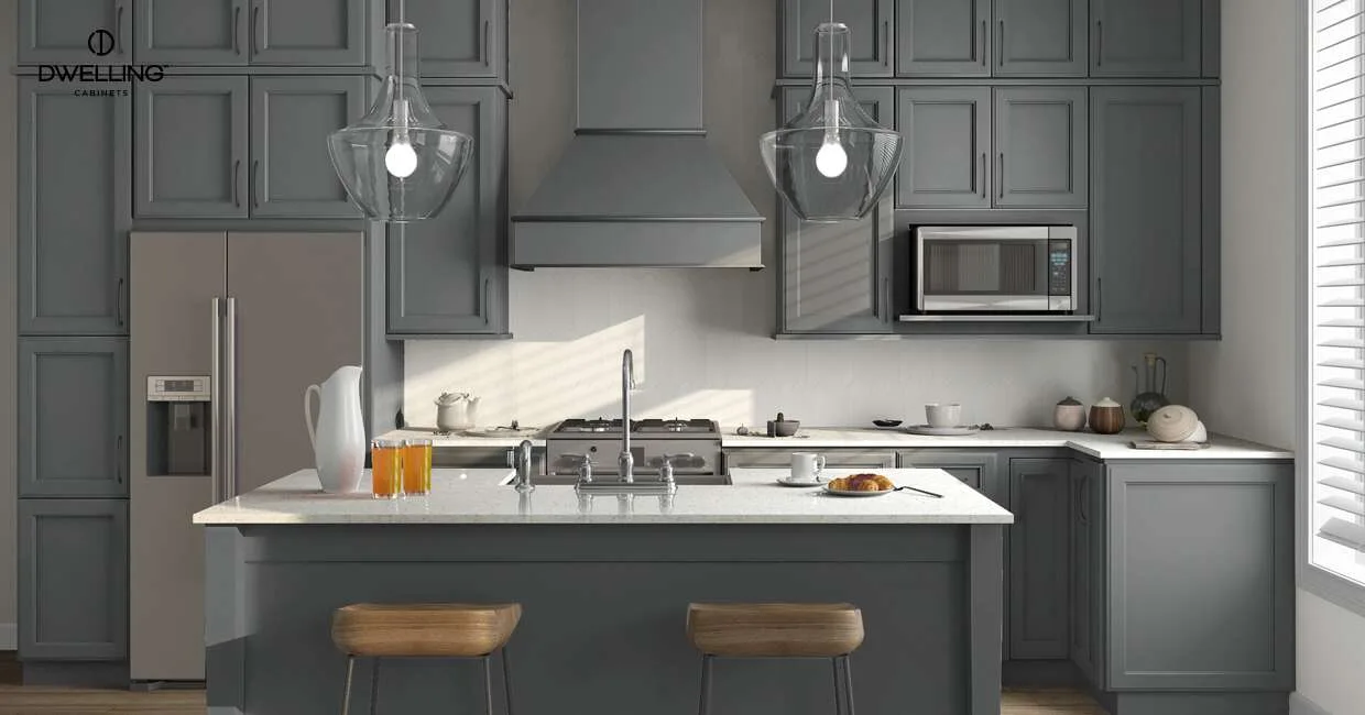 A transitional kitchen featuring grey shaker-style cabinets, a central gray island with white quartz countertops, and two wooden counter stools.