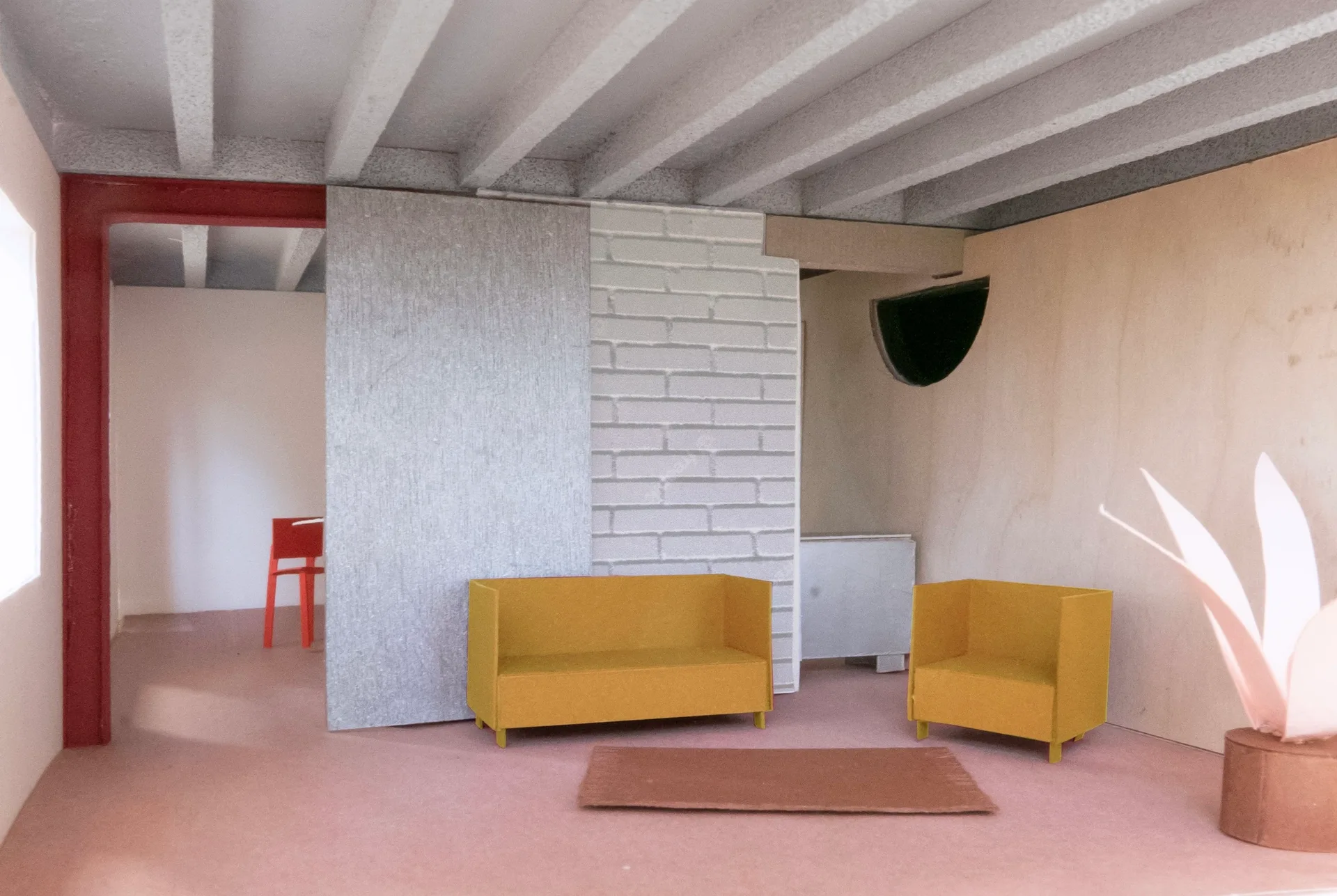 An architectural scale model of a miniature living room features a yellow sofa, an armchair, exposed ceiling beams, and a textured partition wall.