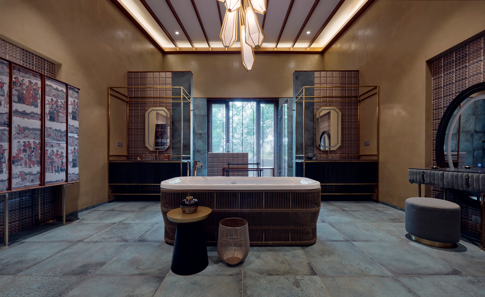 A large bathroom features a central rattan-wrapped bathtub, dual vanities with gold frames, teal floor tiles, and a beamed ceiling with a geometric pendant.