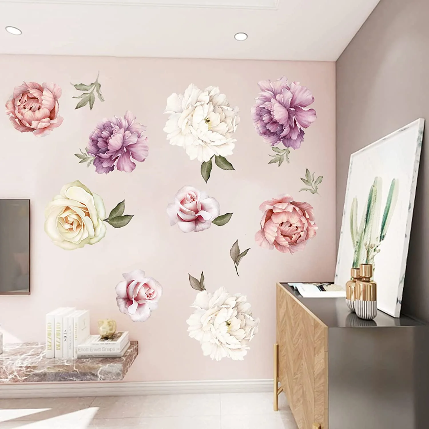 Individual watercolor peony wall stickers decorate a soft pink wall above a wooden console and a floating marble shelf.