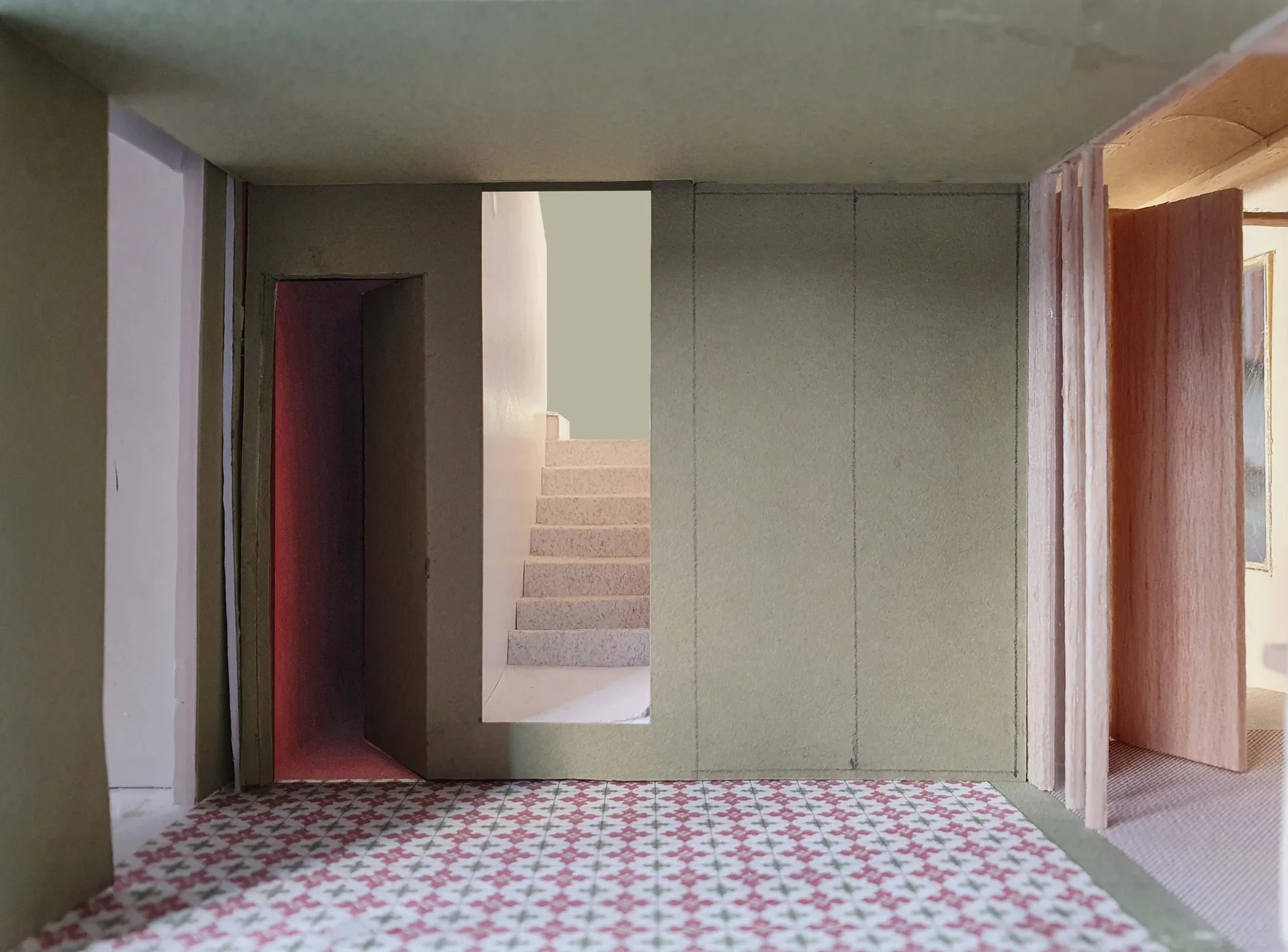 An architectural scale model showing olive green walls, a miniature central staircase, and a red and white geometric tile floor.