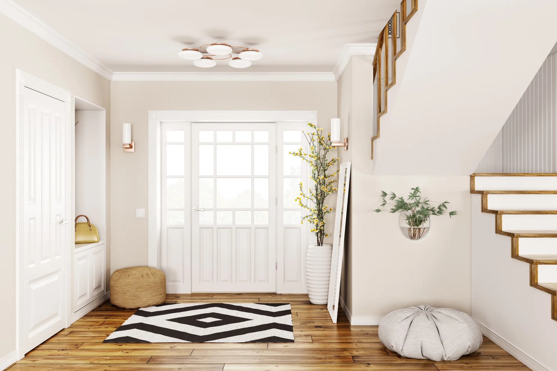 A cream entryway features a white front door with glass panes, wood flooring, a black and white geometric rug, and a wooden staircase.