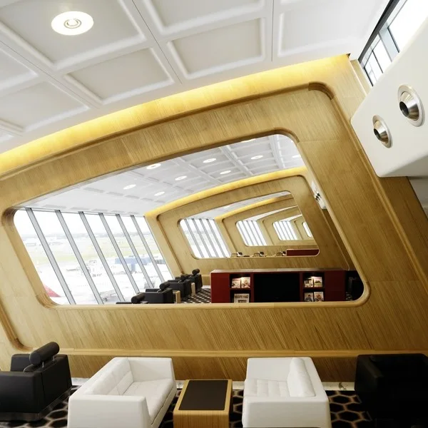 A futuristic transit lounge with angled wood-paneled walls, slanted windows, white leather sofas, and a white coffered ceiling.