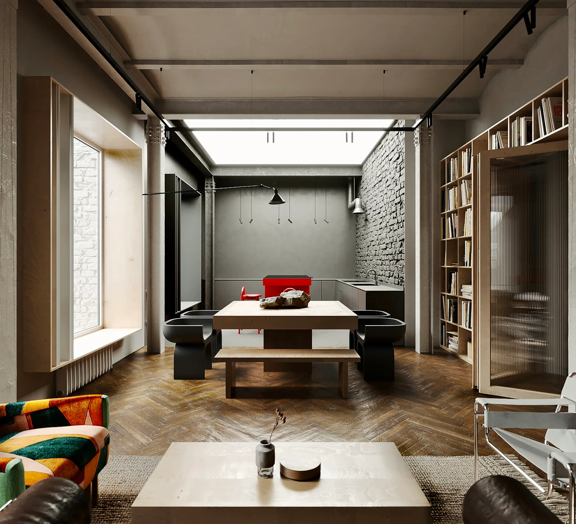 An open-plan dining and living space features a central wooden dining table under a large skylight, an exposed brick wall, and herringbone floors.