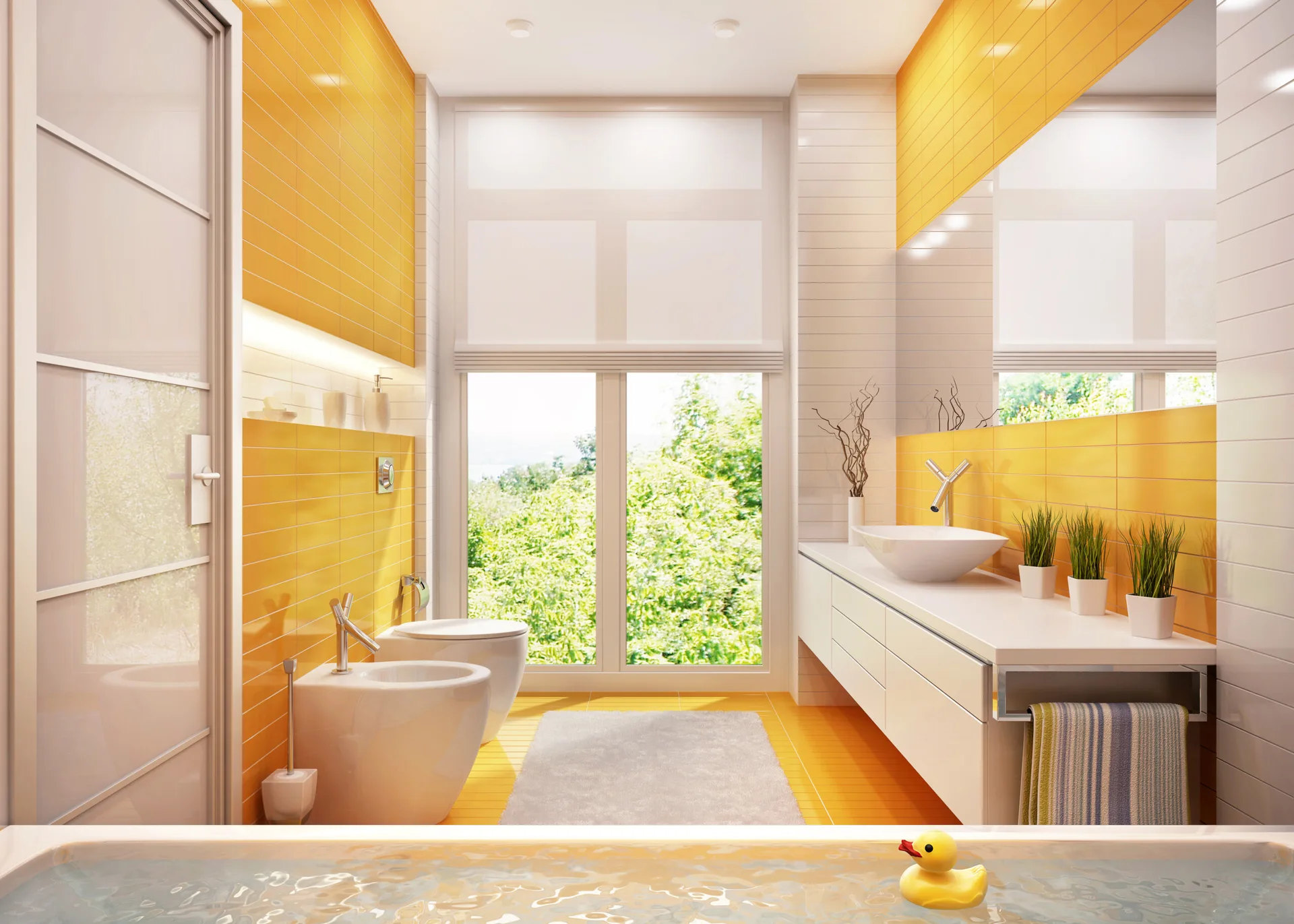 A modern bathroom with bright yellow wall tiles, a floating white vanity with a vessel sink, a wall-mounted toilet, and a window overlooking trees.