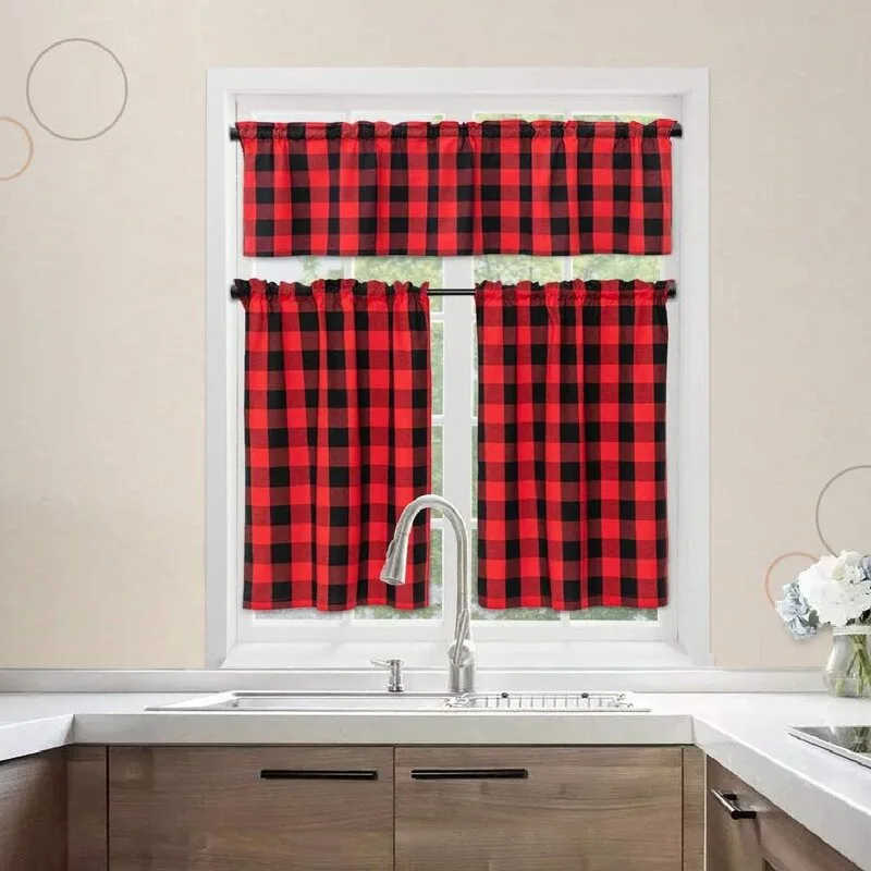 A white kitchen window is dressed with red and black buffalo check cafe curtains and a matching valance above a stainless steel sink.