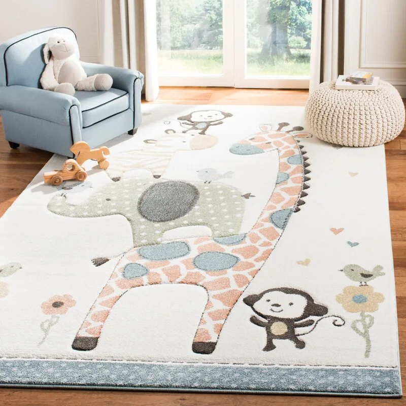 A nursery features a large white rug decorated with animal illustrations, a small light blue armchair, and a knitted beige pouffe on a wood floor.