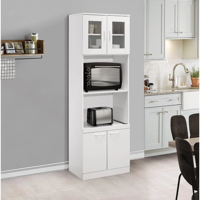 A tall white kitchen pantry cabinet features upper glass doors, middle shelves holding a microwave and toaster, and solid double doors below.